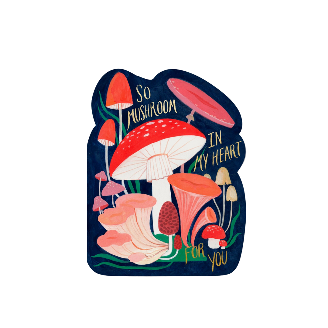 Illustrated mushrooms on a blue background with gold text " So Mushroom In My Heart For You". Blank inside. 100lb heavyweight card stock. Die cut, offset printed and foil stamped. 5 x 7 inches. Illustrated by Kelsey Garrity Riley. Printed in USA on recycled paper. Illustrated by Kate Pugsley.